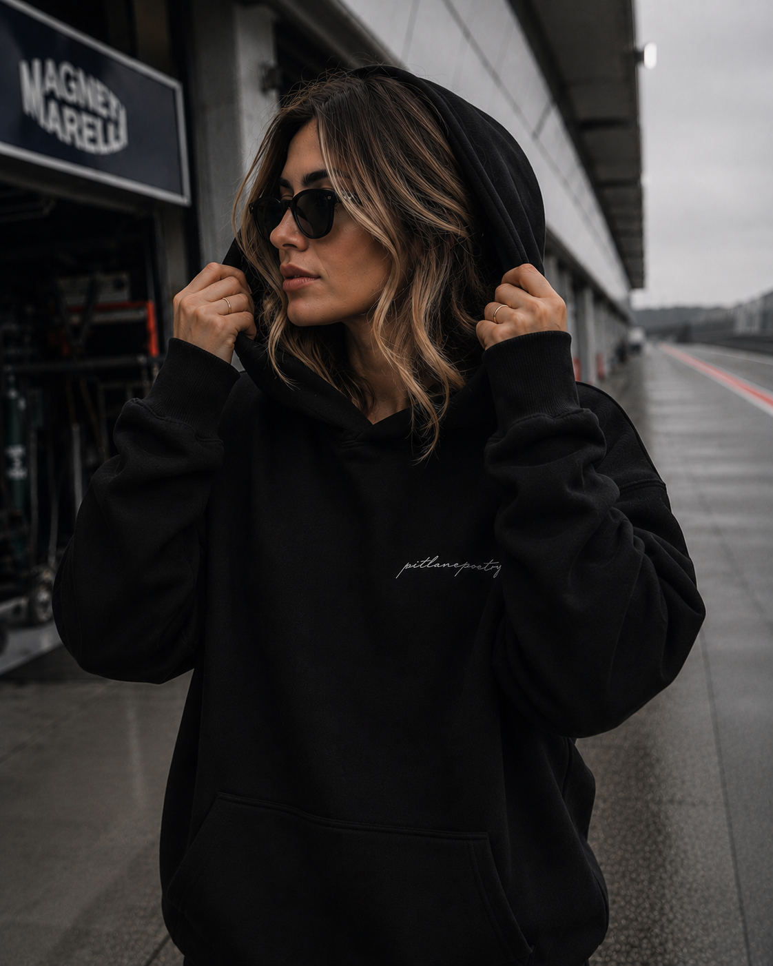 PITLANEPOETRY DROP 001 black hoodie worn in the pit lane