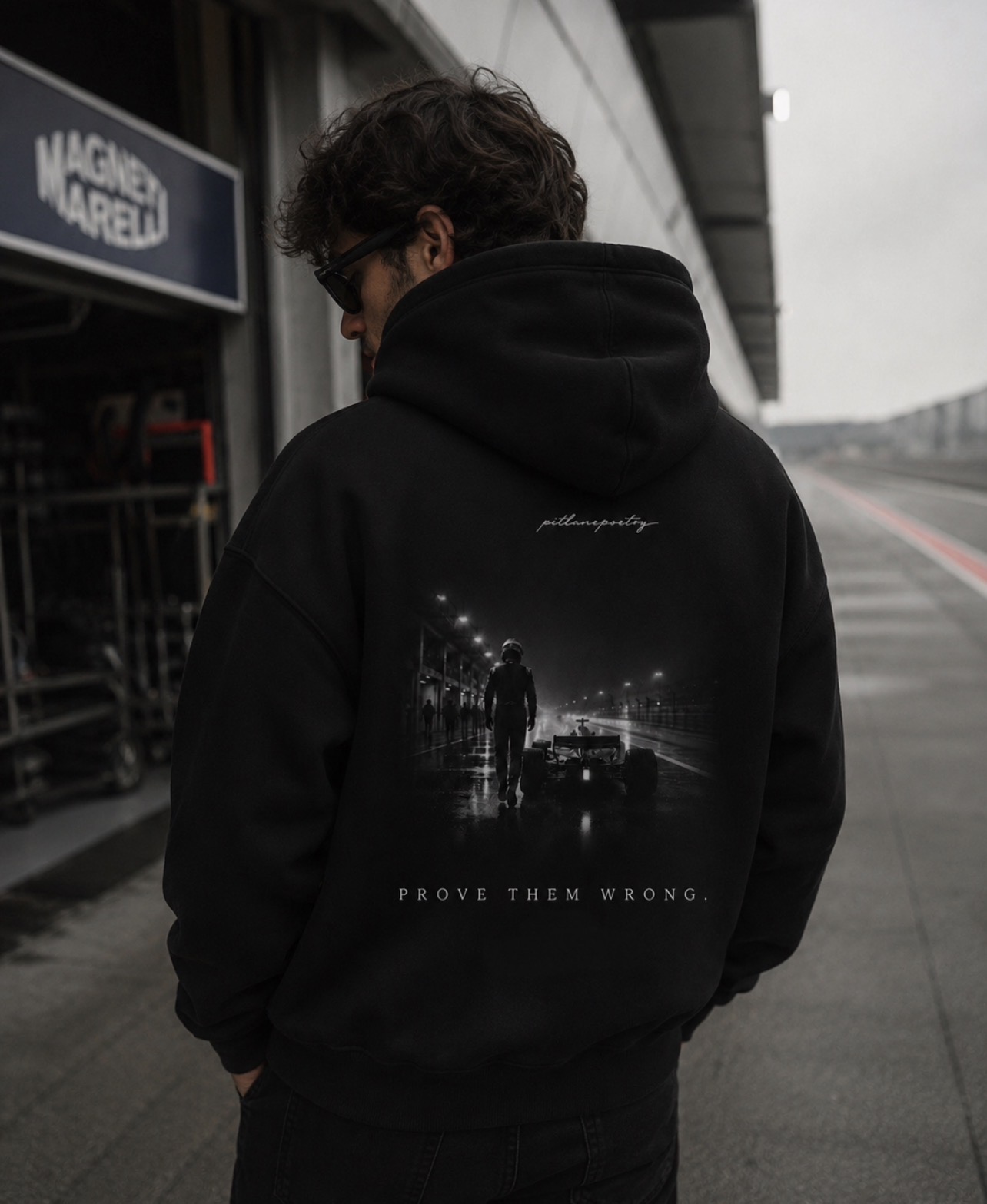 Back view of the PITLANEPOETRY hoodie worn trackside